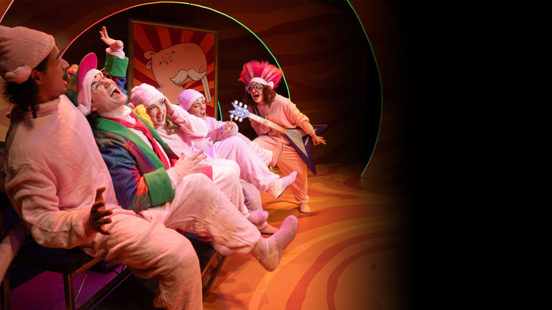 People dressed in naked molerat costumes, one is playing the electric guitar